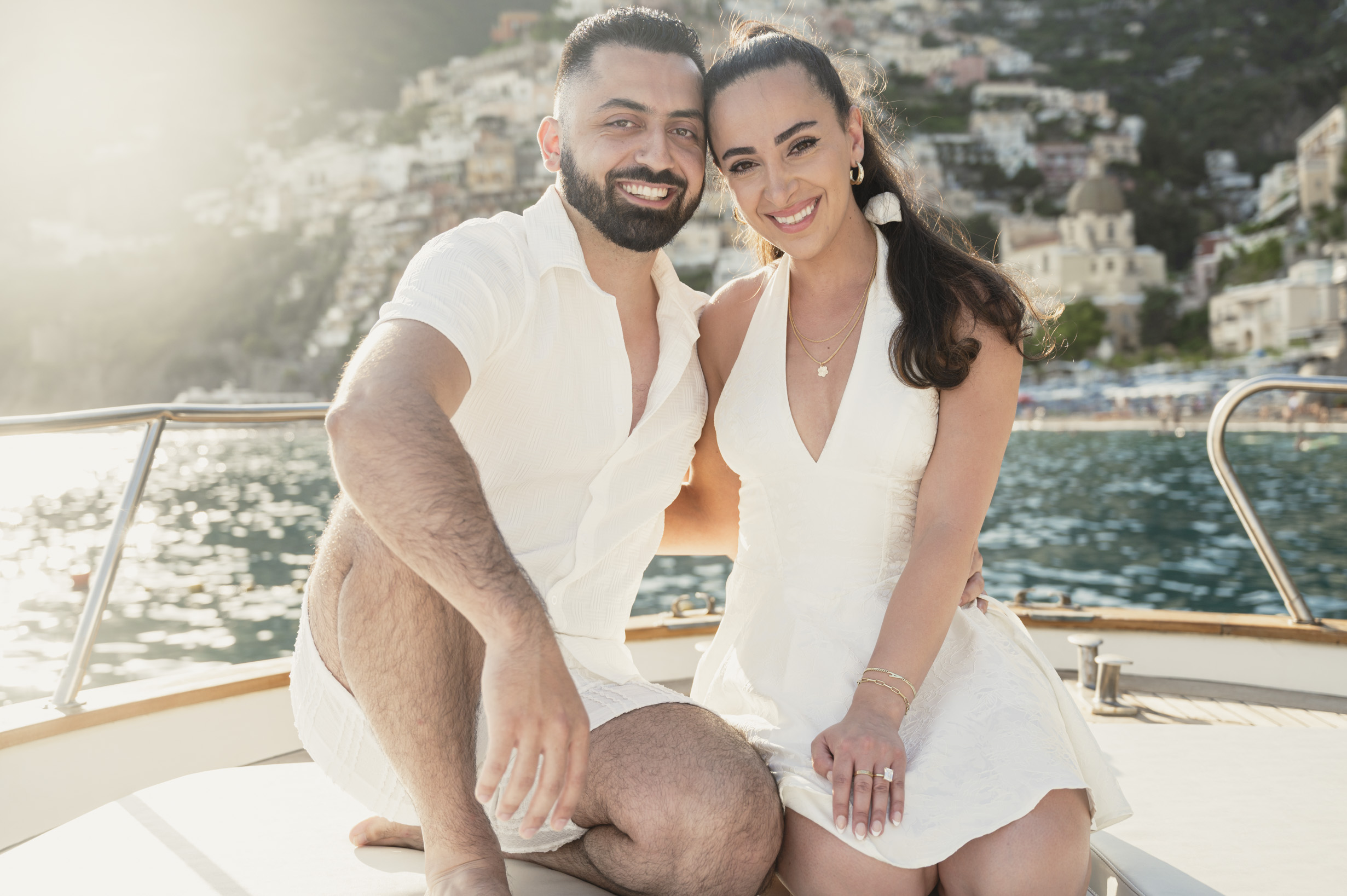 Auria and Ayda smiling together on the boat just after their proposal in Positano